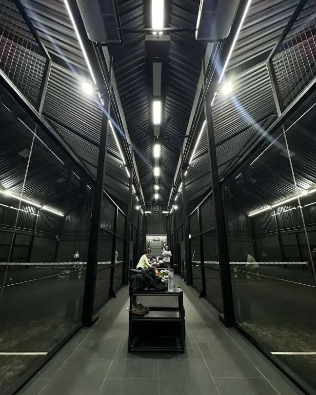 The glass corridor between the two courts