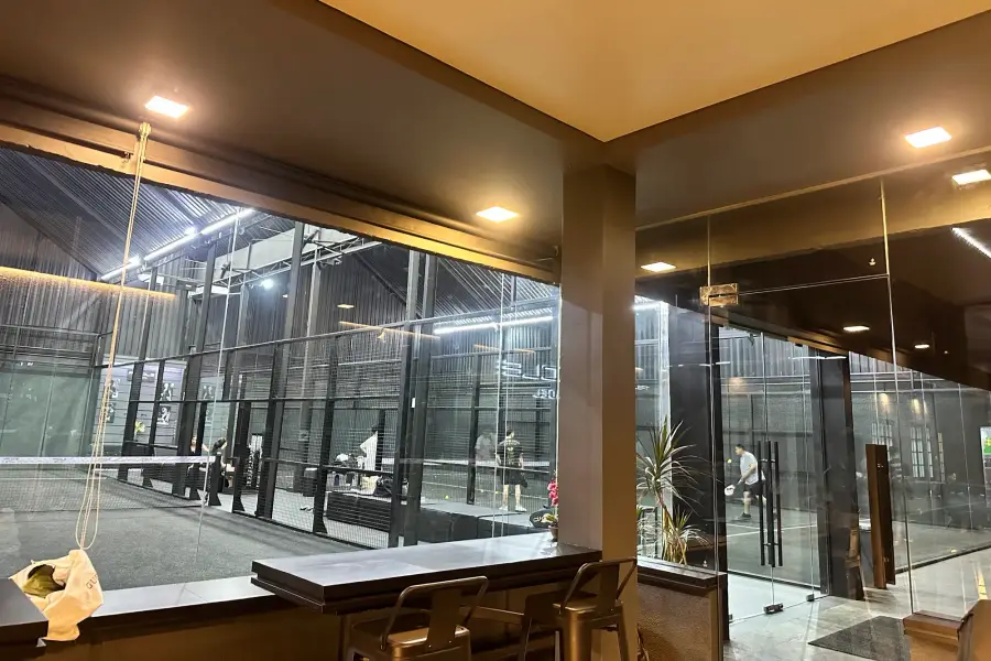 Bar counter looking through glass onto the courts