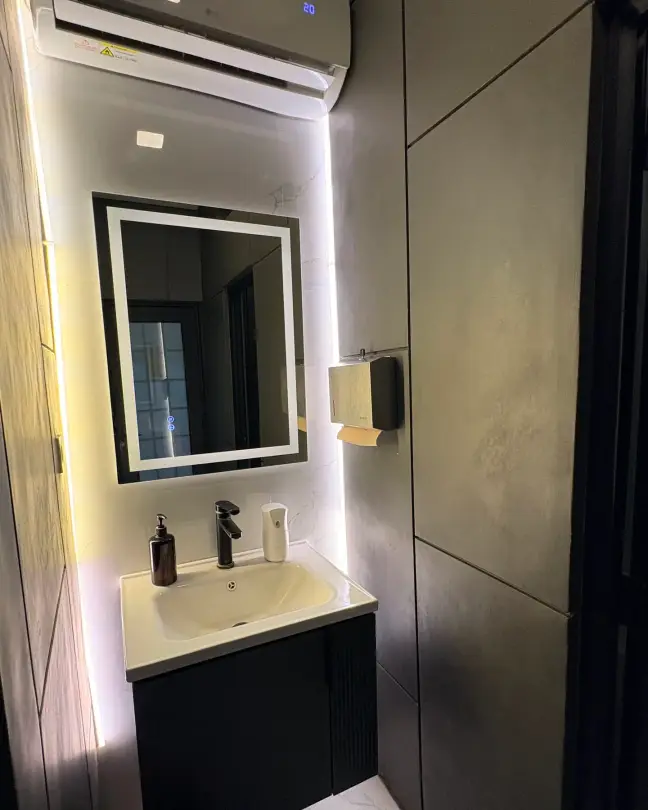 Washroom with a backlit mirror